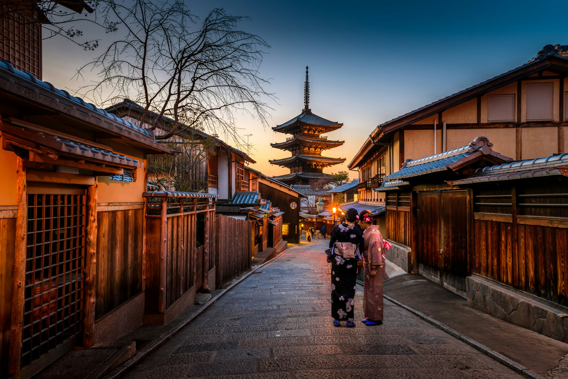 Woman in kimono walking a traditional Kyoto street
